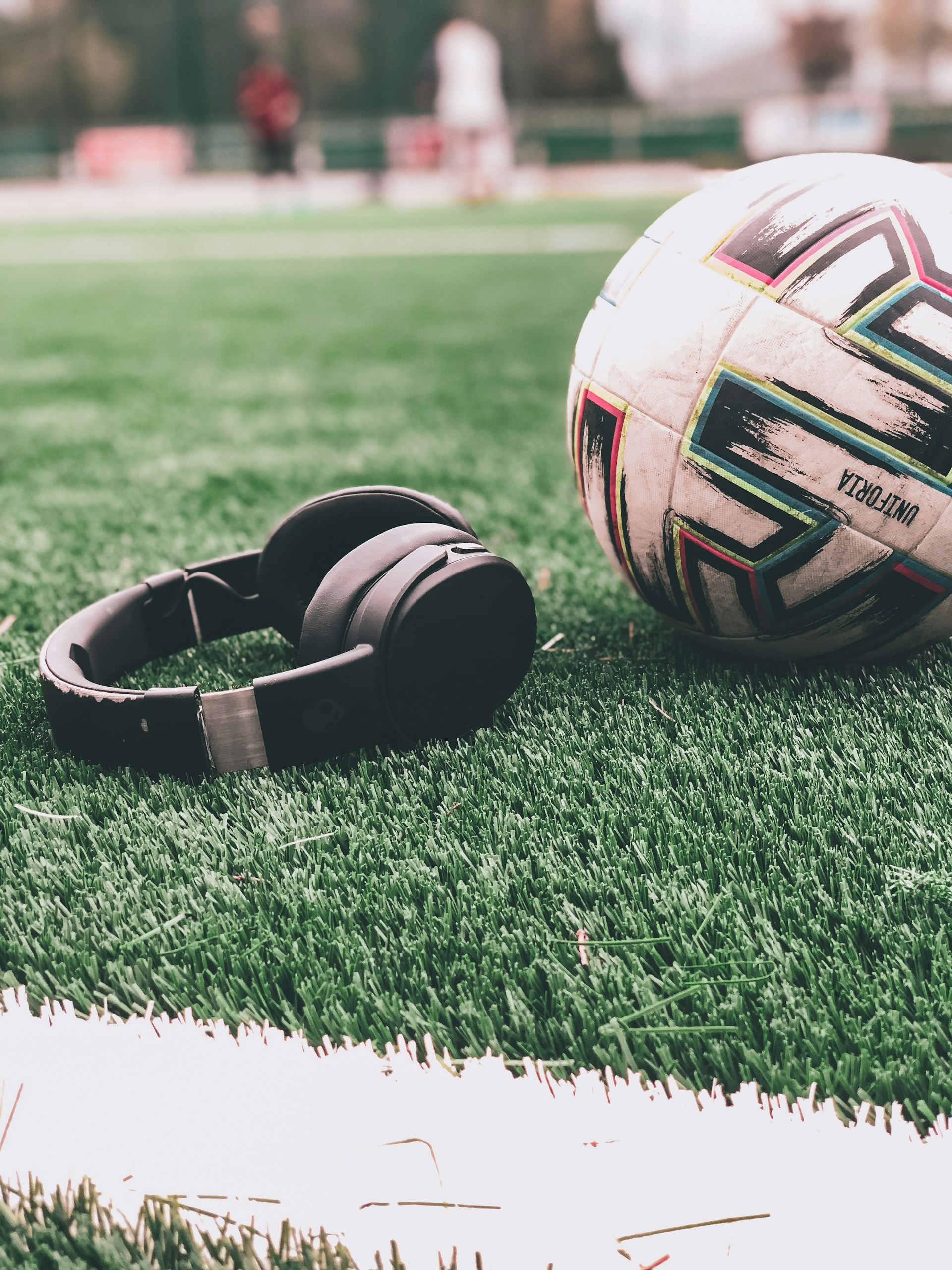 a soccer ball sitting on top of a lush green field