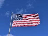 an american flag waving in the wind