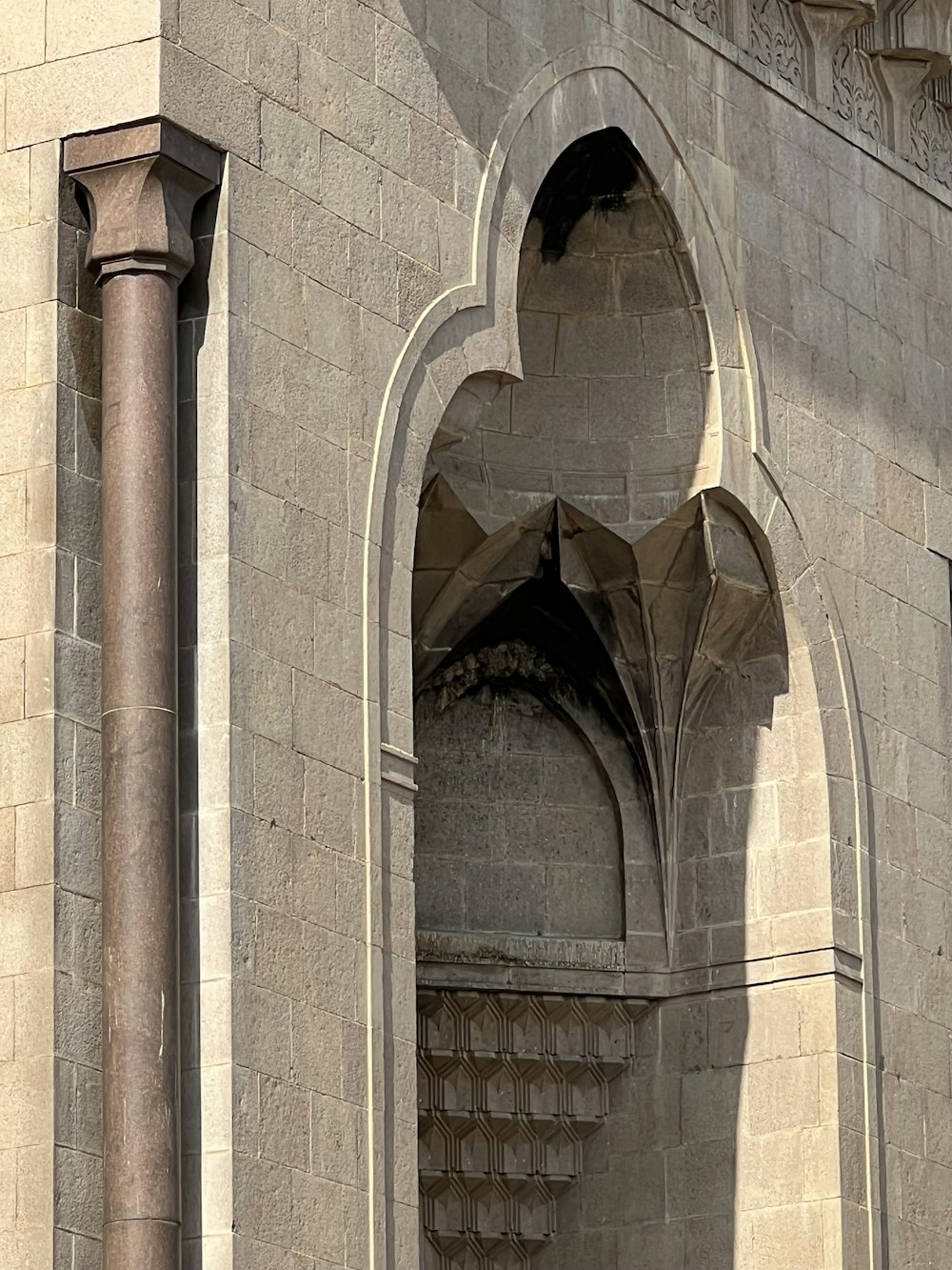 a large stone building with a clock on it's side