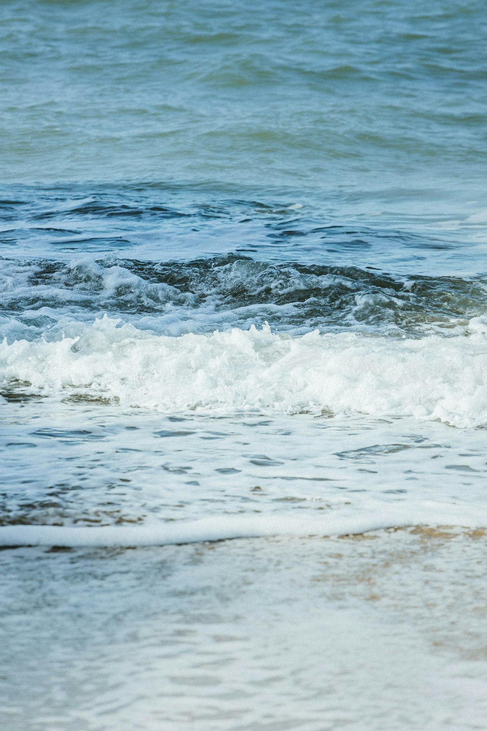 a man riding a wave on top of a surfboard