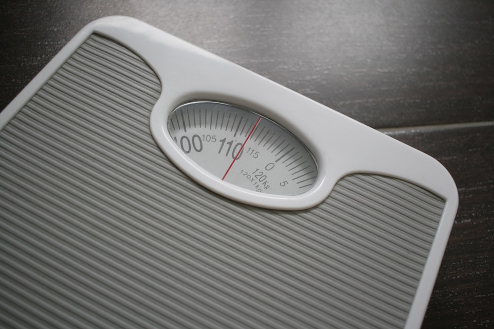 a bathroom scale sitting on top of a wooden table