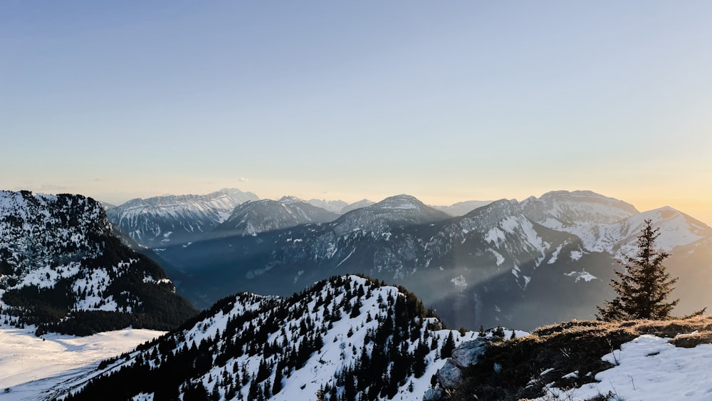 a person standing on top of a snow covered mountain