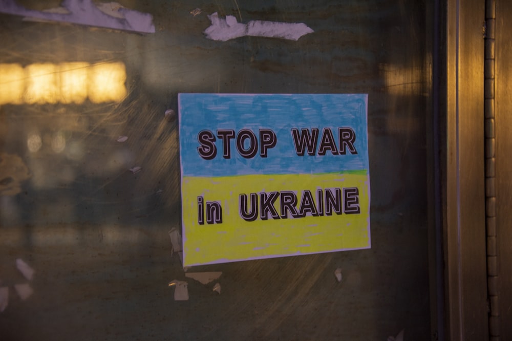 a sign on a door that says stop war in ukraine