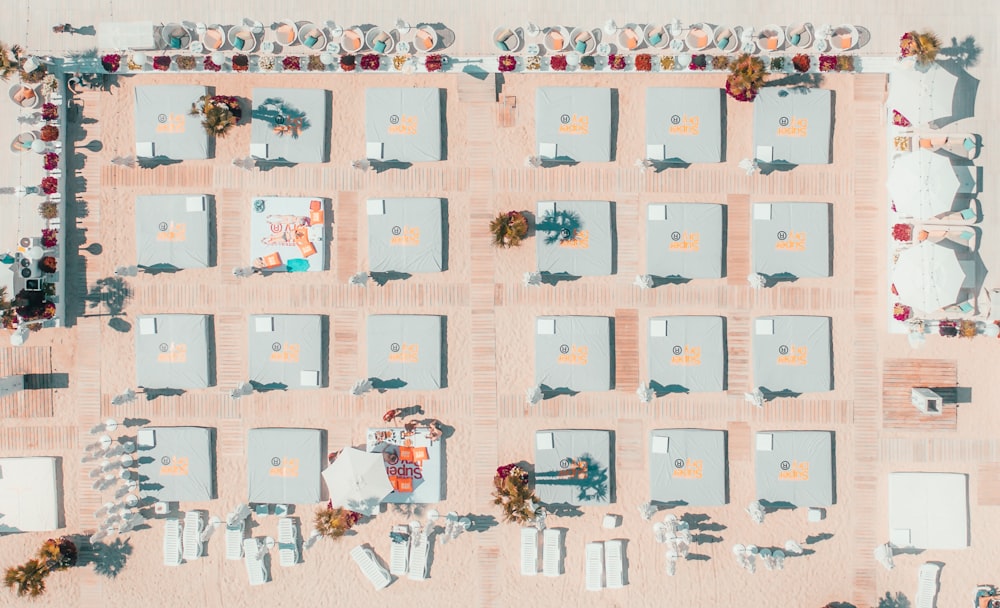 an aerial view of a beach with chairs and umbrellas