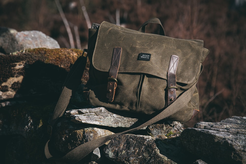 a brown bag sitting on top of a pile of rocks