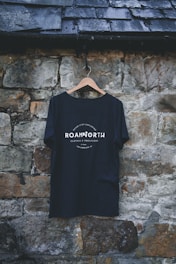 a t - shirt hanging on a stone wall