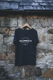 a t - shirt hanging on a stone wall