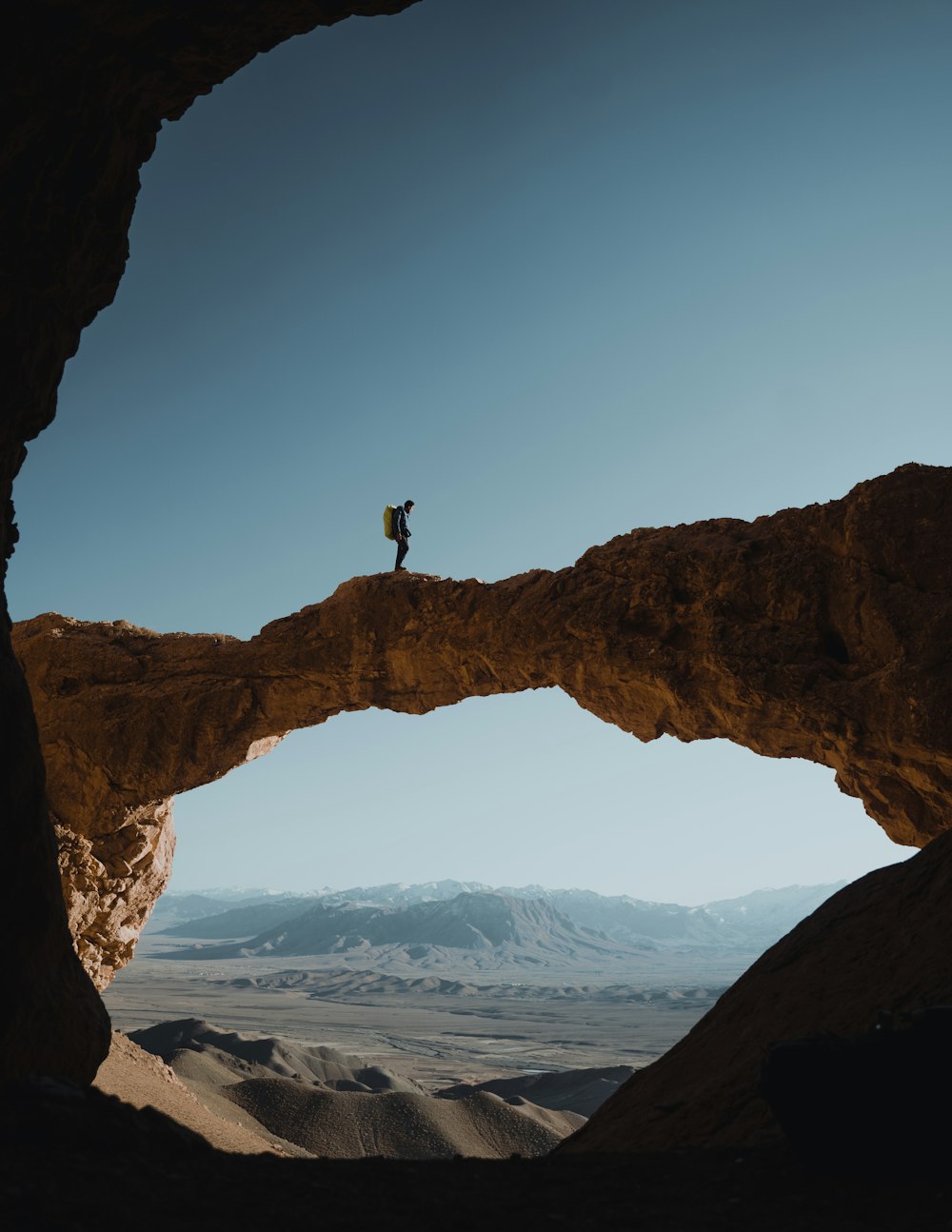 a person standing on top of a rock formation