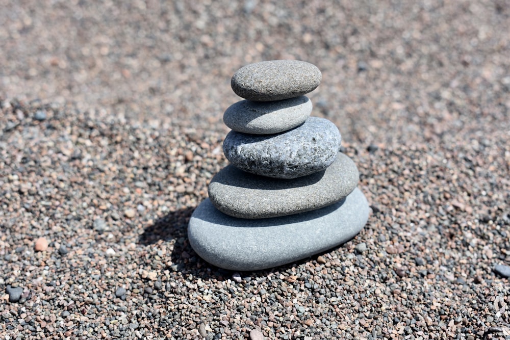 a stack of rocks sitting on top of a sandy beach