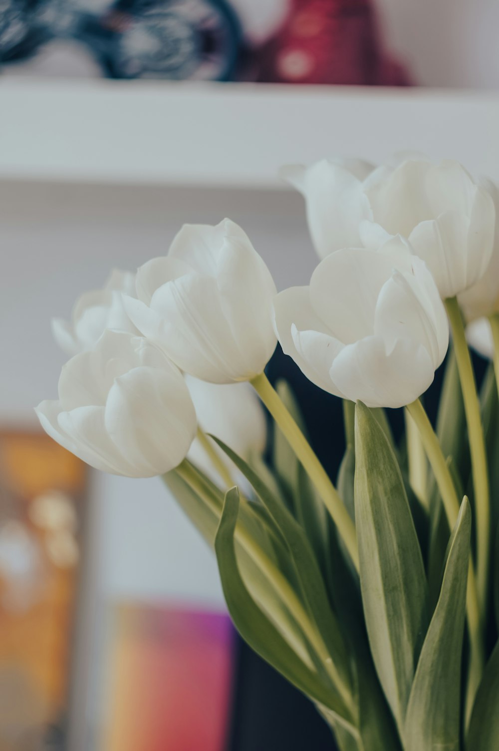 a vase filled with white flowers on top of a table