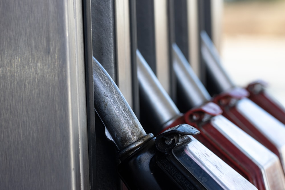 a row of knives hanging on the side of a building