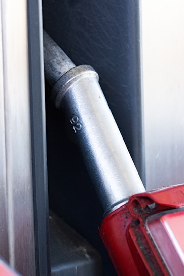 a red umbrella sticking out of a metal door