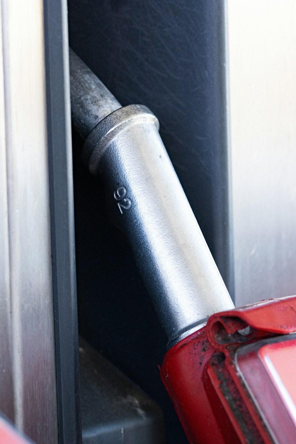 a red umbrella sticking out of a metal door