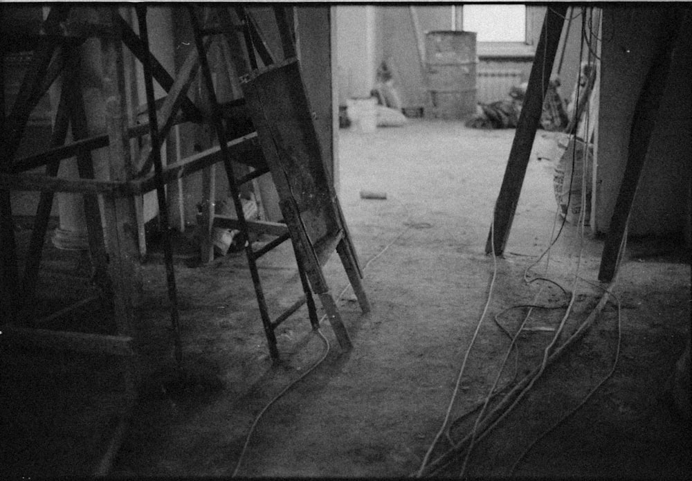 a black and white photo of a room with ladders