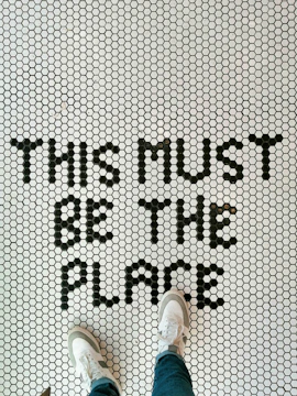 a person standing on a tiled floor with the words trust is the place