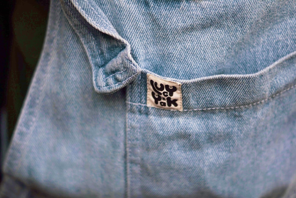 a close up of a person wearing a jean jacket