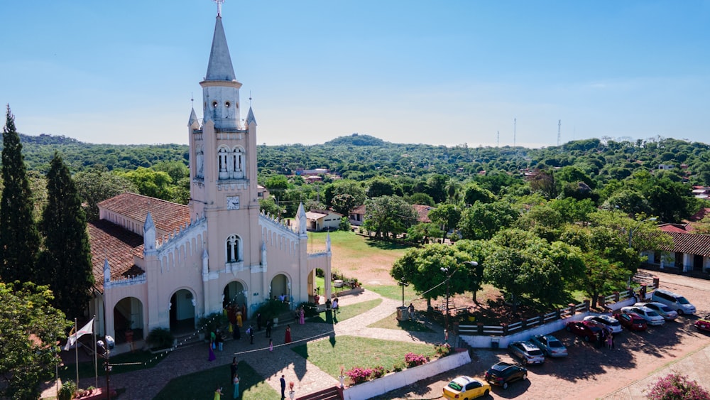 an aerial view of a church with cars parked in front of it