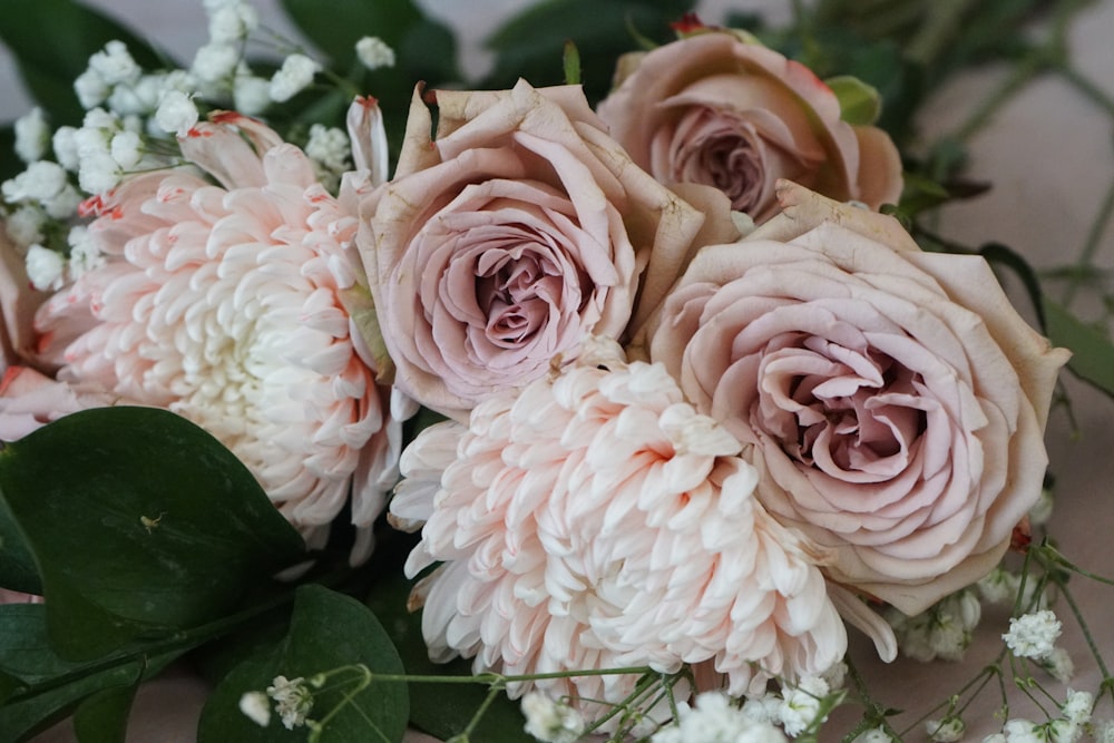 a bouquet of pink and white flowers on a table