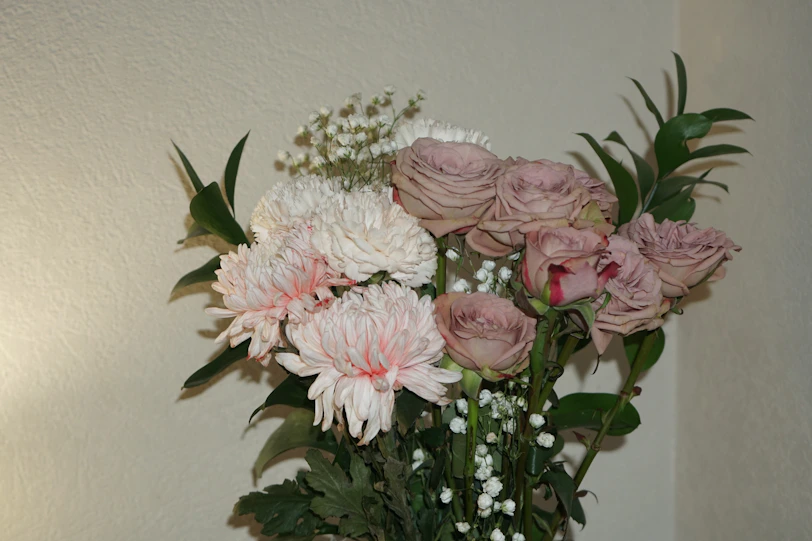 a vase filled with pink and white flowers