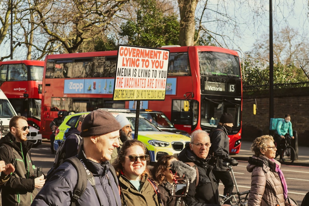 a group of people standing on the side of a road