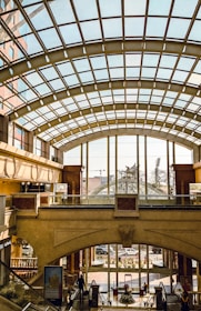 Wide-angle view of an empty mall atrium bathed in natural light, hinting at upcoming changes.