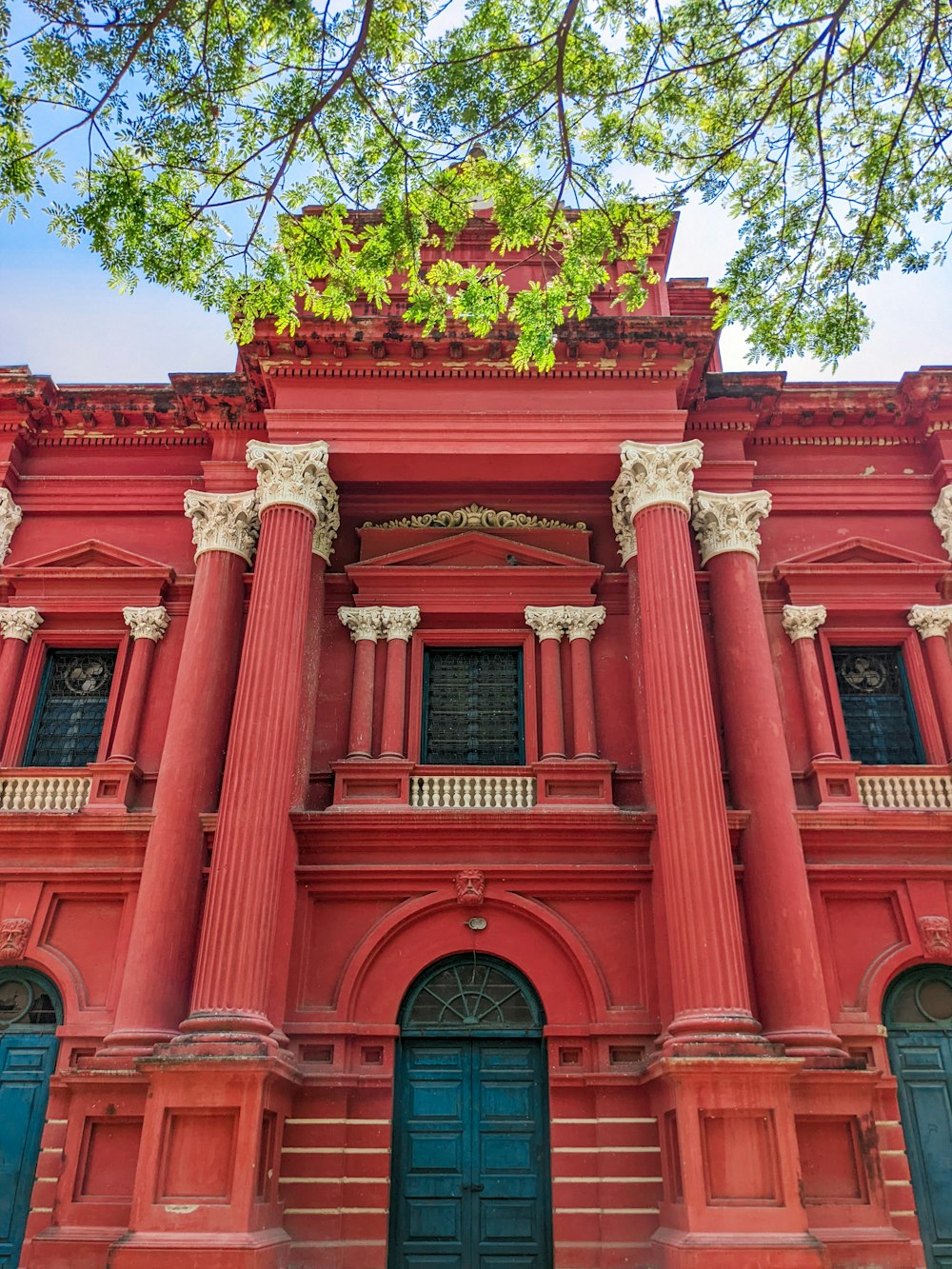 a large red building with two blue doors