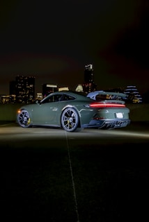 A sleek Japanese sedan parked against a city skyline.