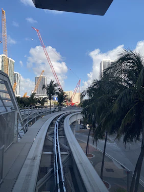 A team of engineers reviewing blueprints at a busy urban light-rail construction site in Los Angeles.