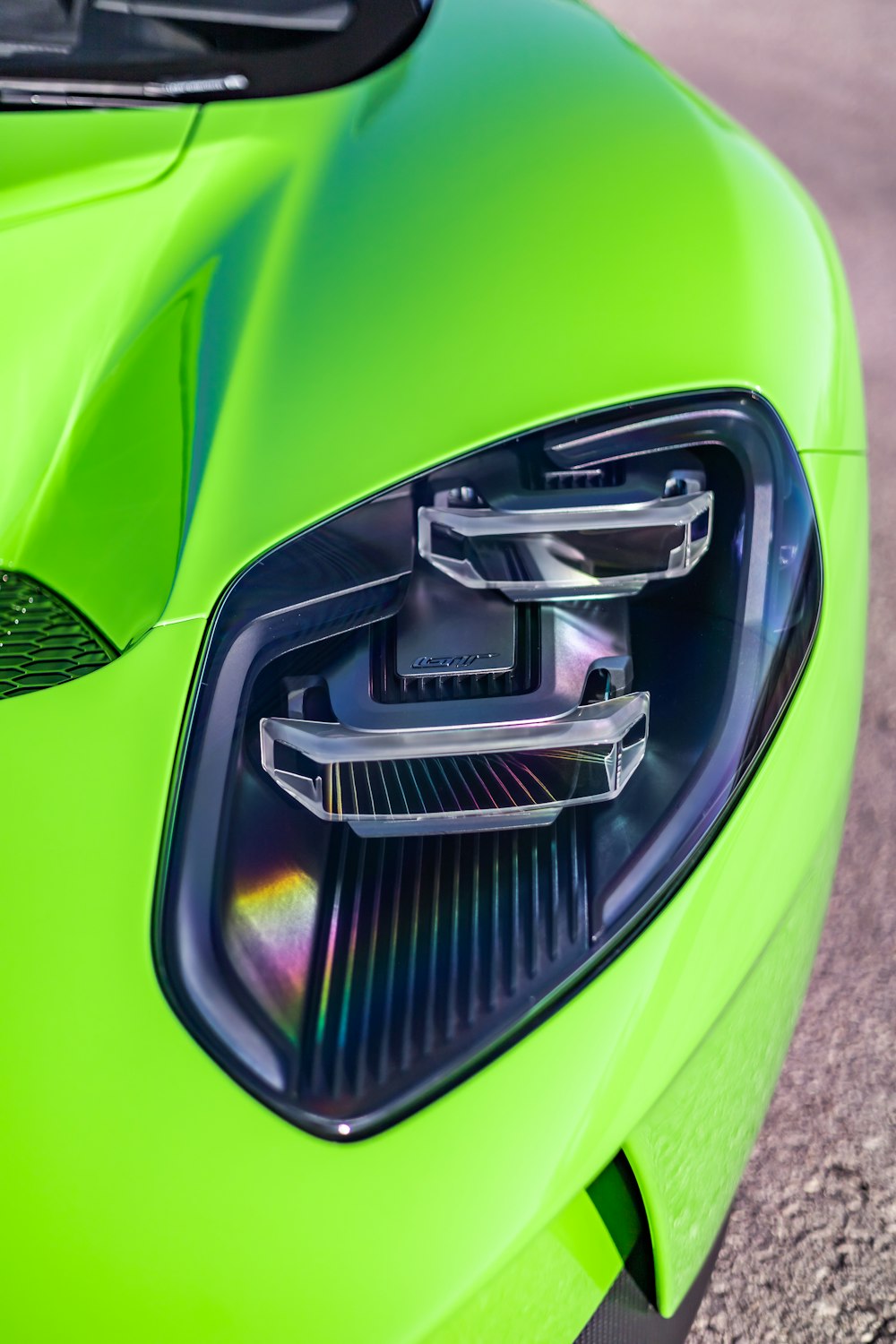 a close up of the front of a green sports car