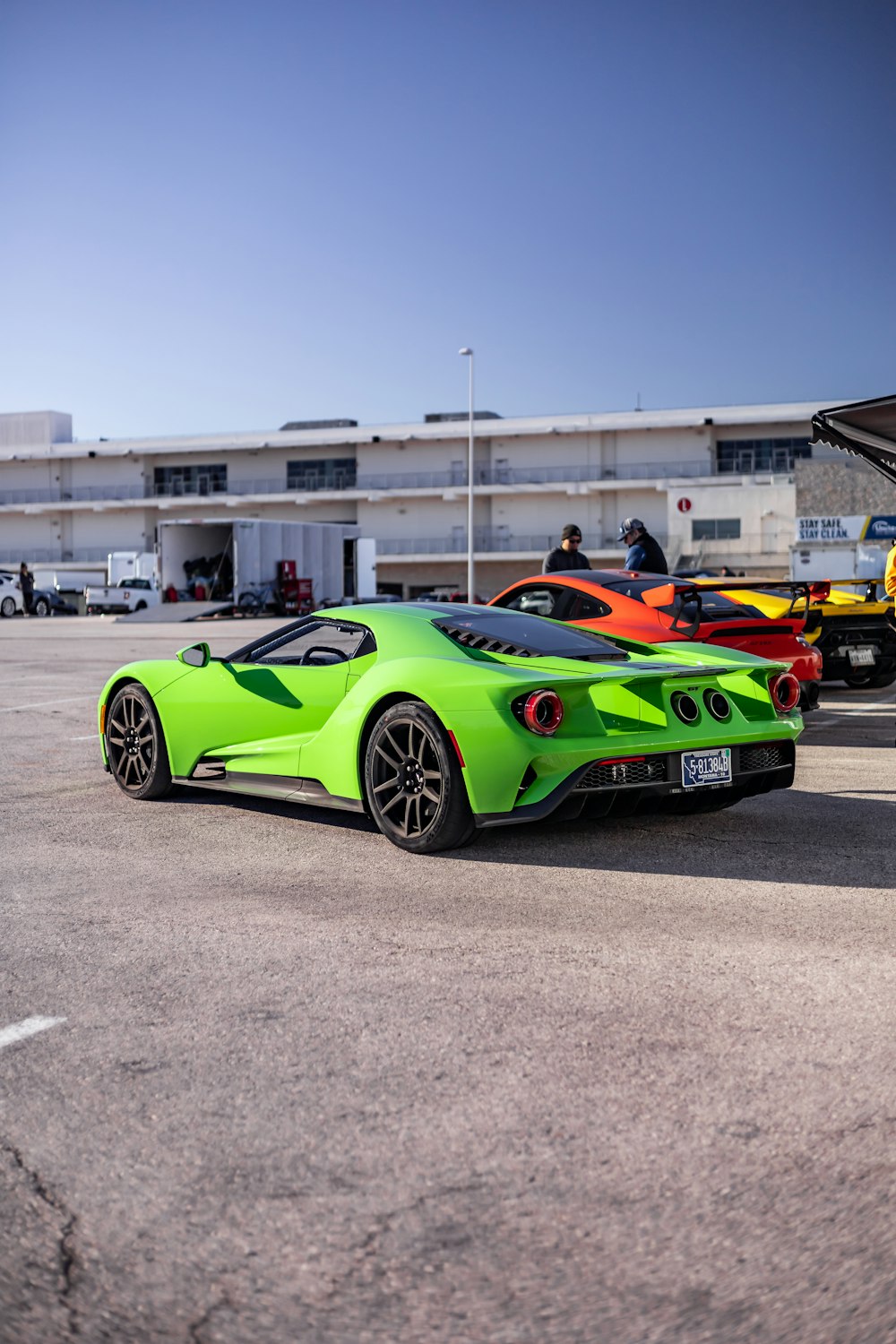 a green sports car parked in a parking lot