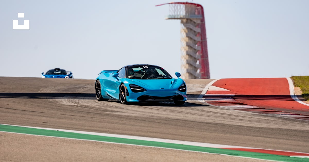 A blue sports car driving on a race track photo – Free Transportation ...