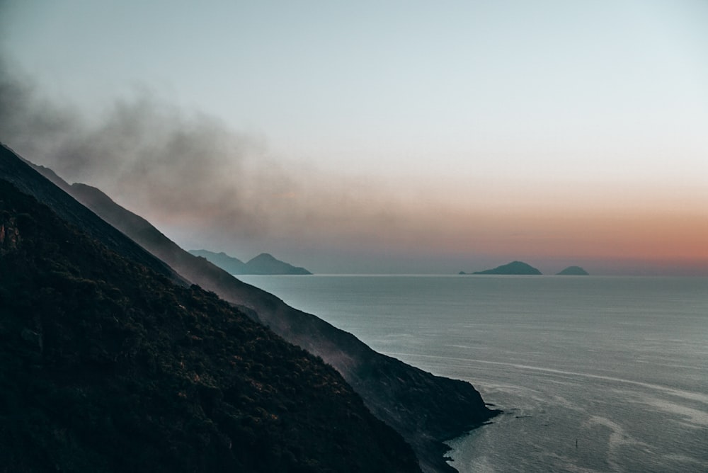 a view of a body of water with mountains in the background