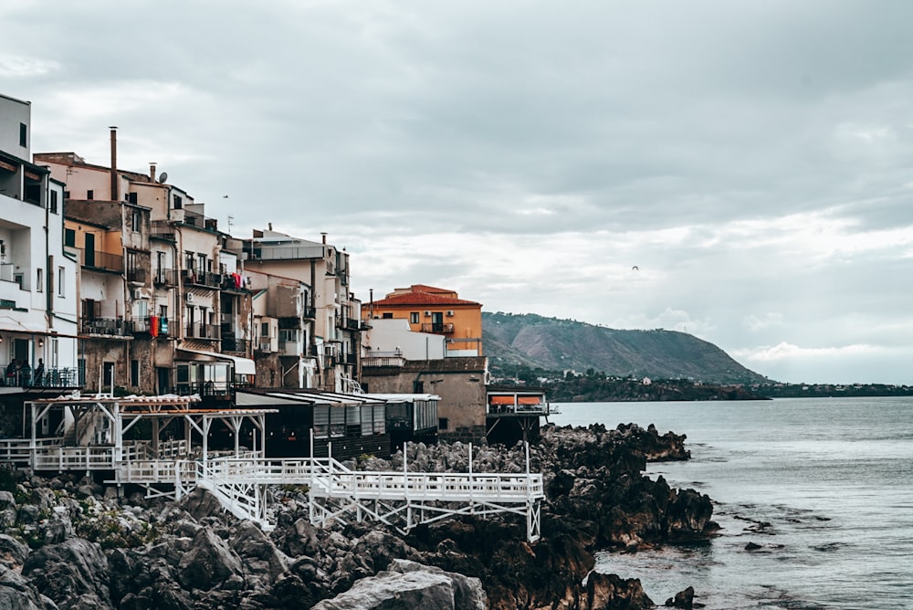 a group of buildings next to a body of water