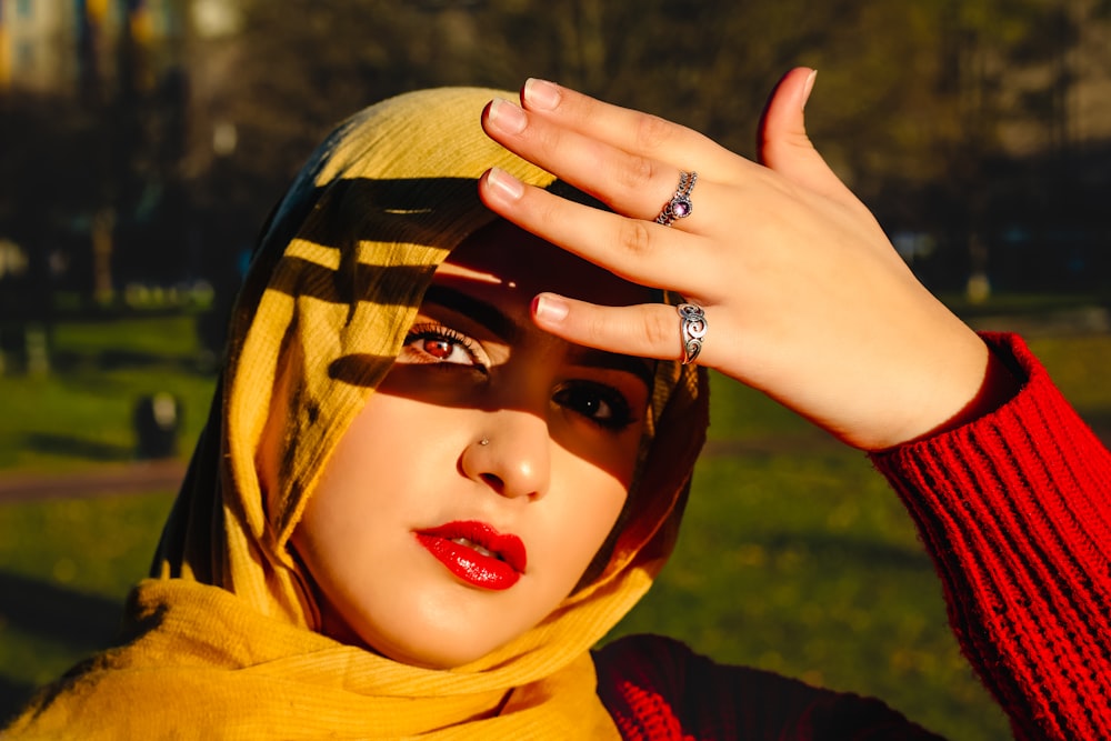 a woman wearing a hijab with a ring on her finger