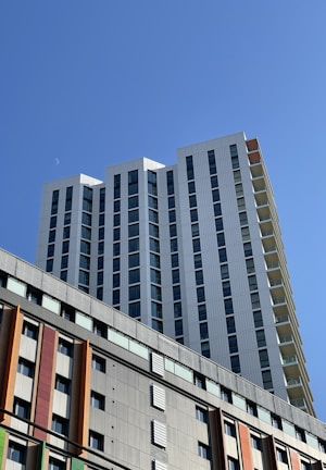 a tall building with multicolored windows against a blue sky