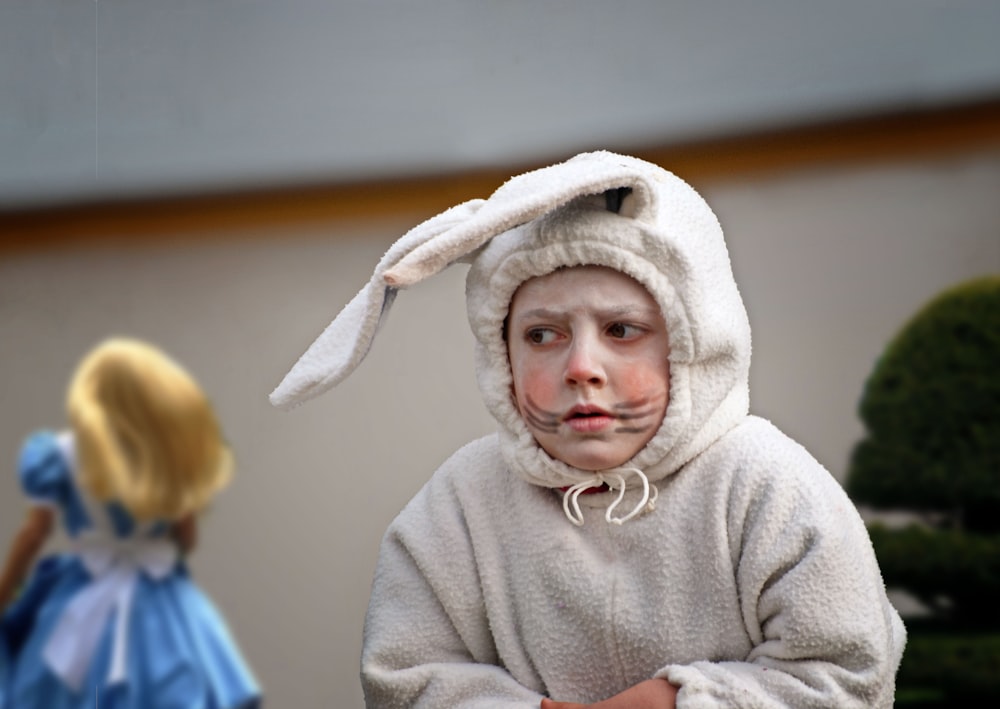 a little girl dressed in a bunny costume