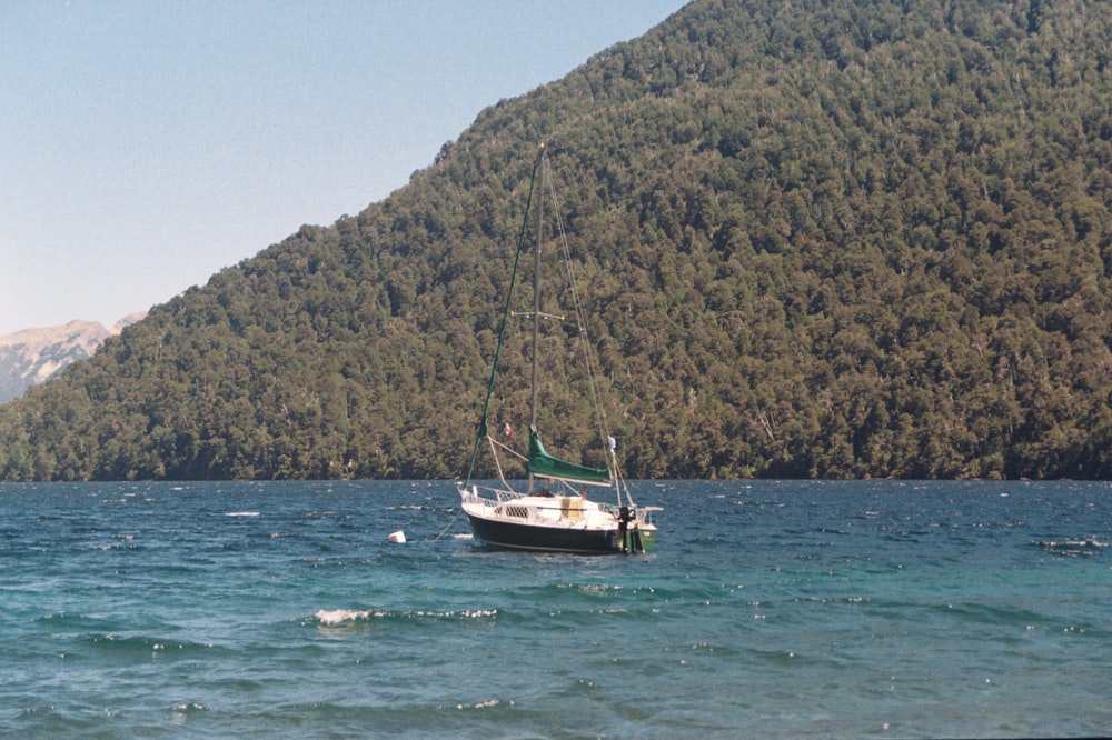 a sailboat in the middle of a body of water