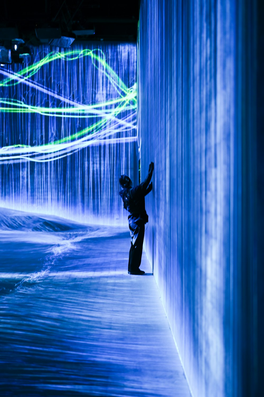 a person standing in a tunnel of water