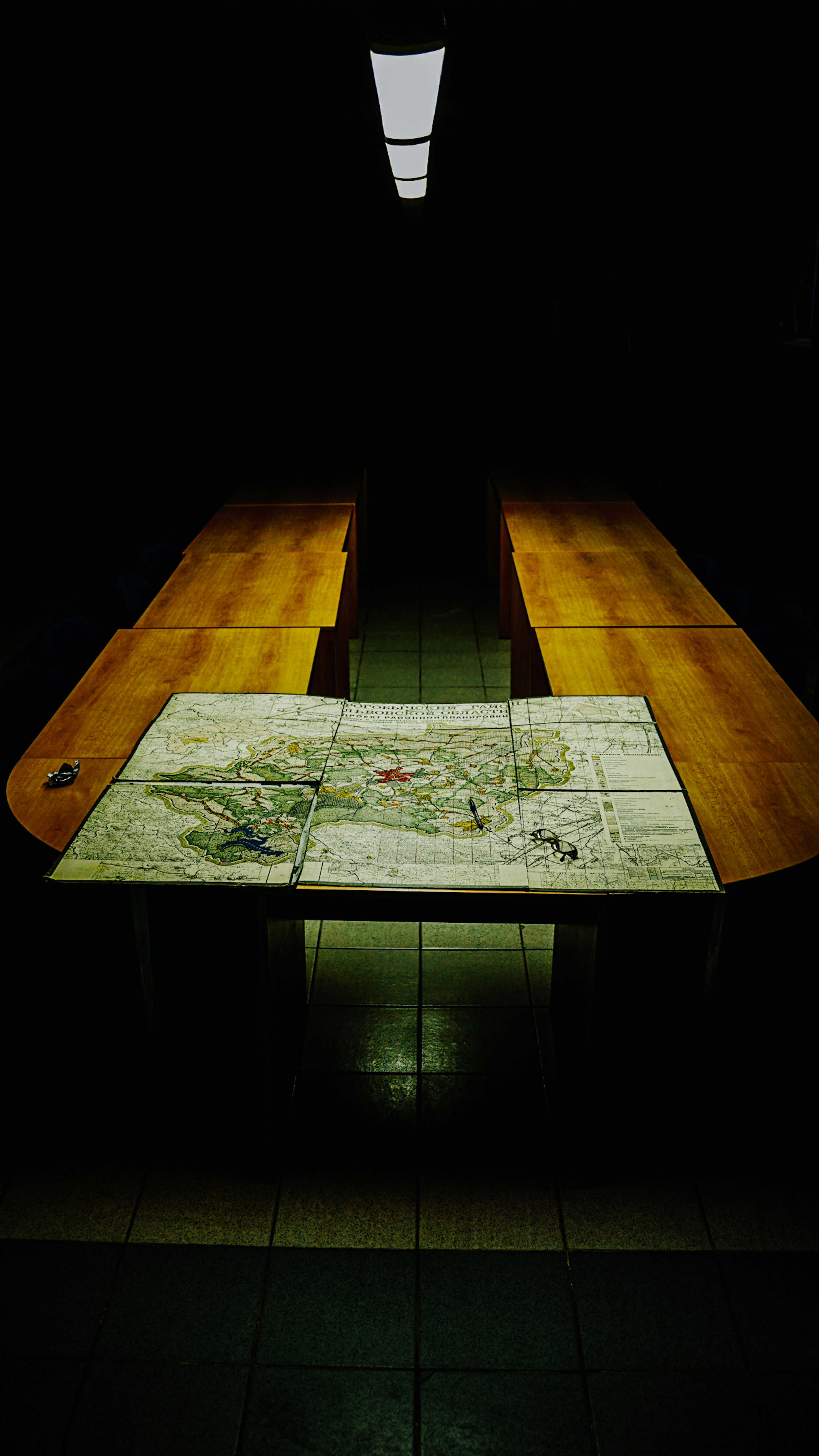 a table with a map on it in a dark room