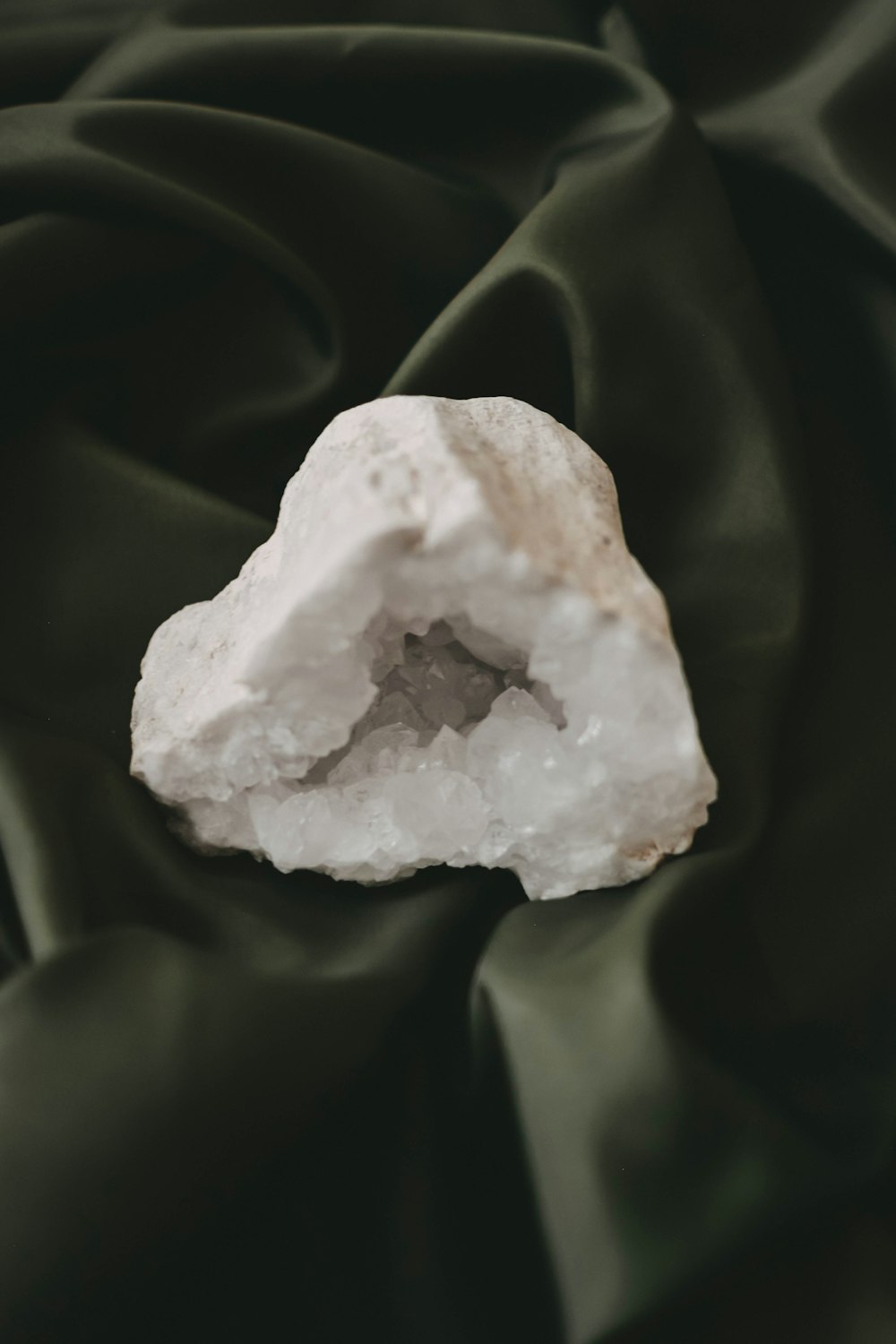 a white rock sitting on top of a green cloth