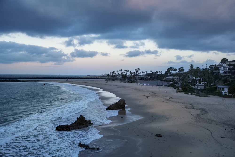 a view of a beach with a few waves coming in