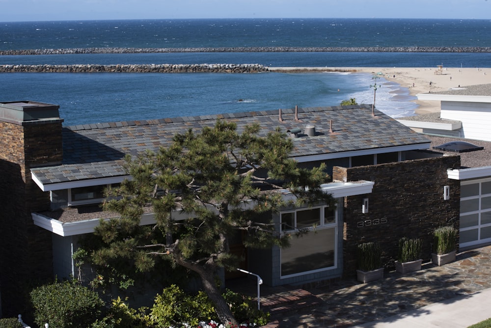 a house on the beach with a view of the ocean