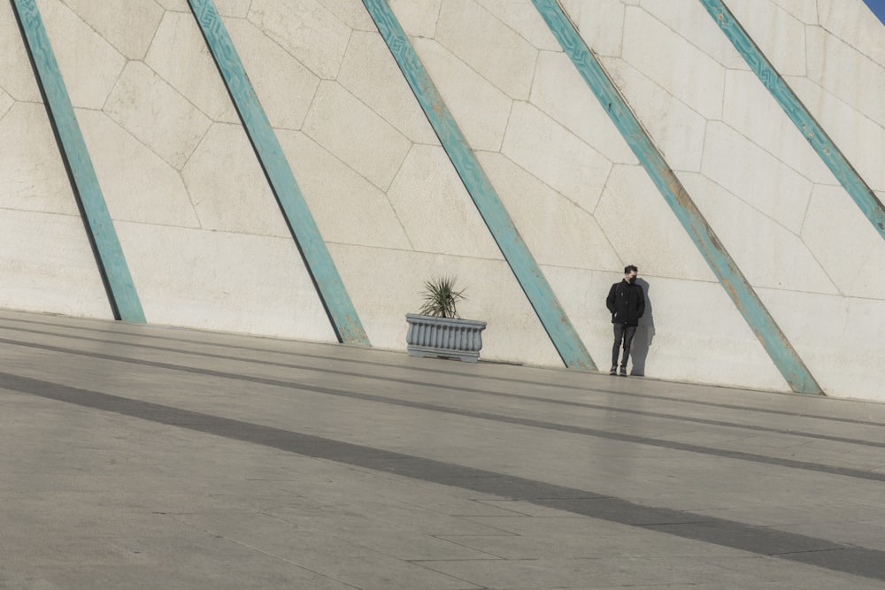 a man is standing in front of a wall