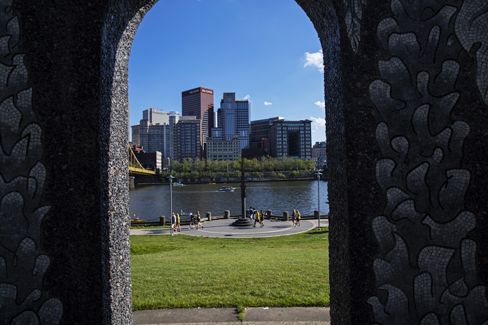 a view of a city through a stone arch
