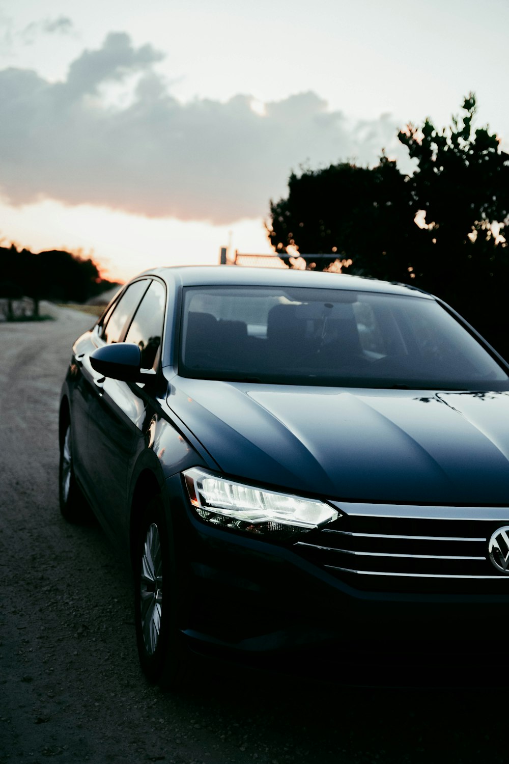 a black car parked on the side of a road