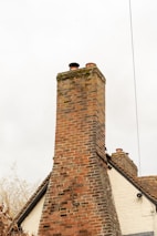 a tall brick chimney on top of a building
