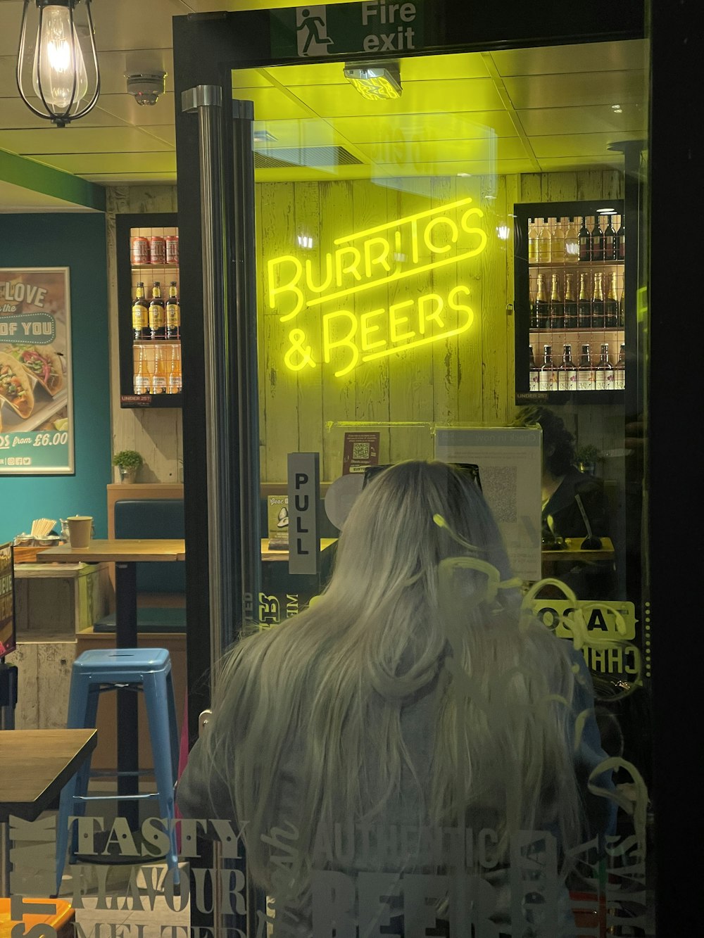 a store front with a neon sign in the window