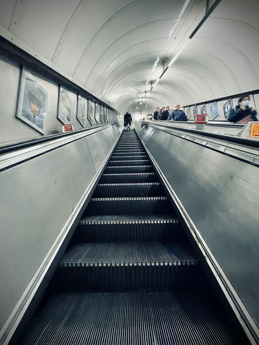 an escalator in a subway station with people on it