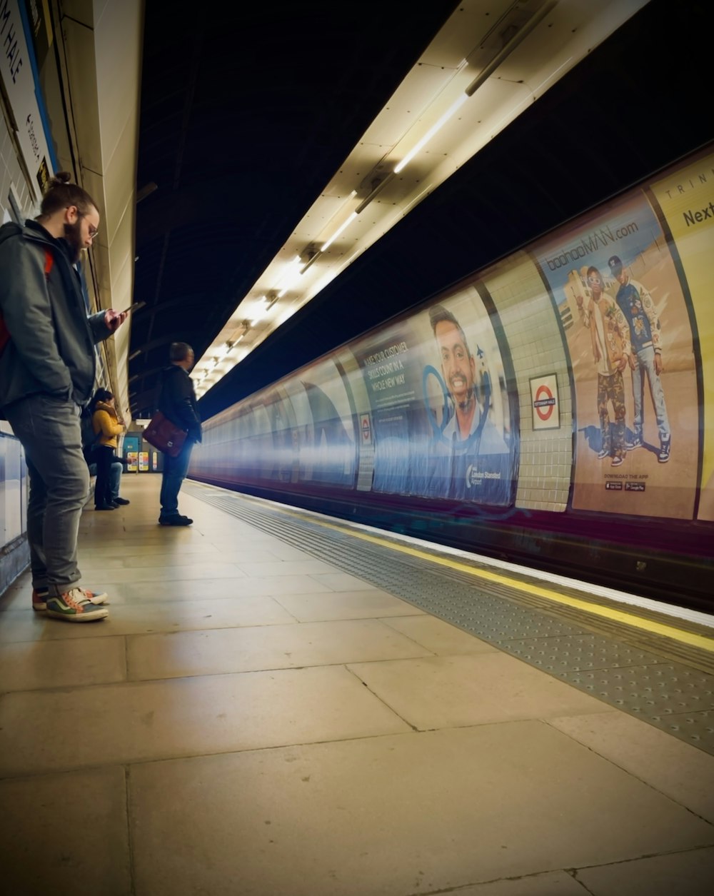 a man standing next to a train at a train station