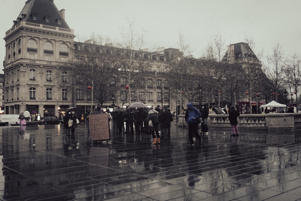 a group of people standing around in the rain